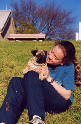 Image 1 of 11. Anika sitting on a hill